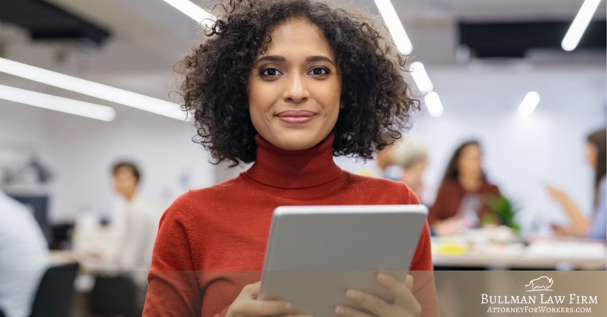 African American female worker holding a tablet